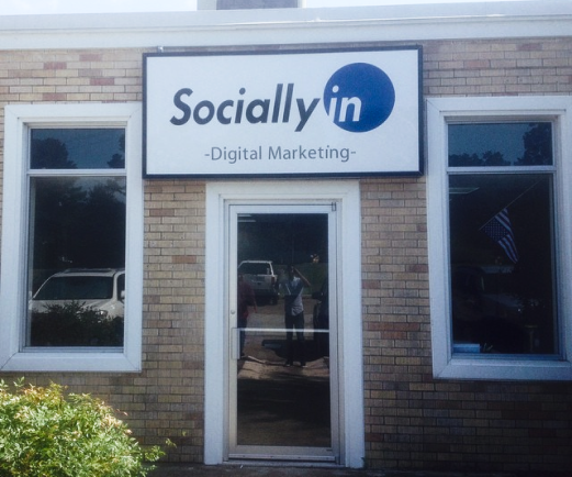 Sociallyin digital marketing old logo hanging in front of an office