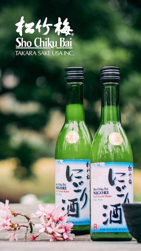 Two bottles of Sho Chiku Bai sake sitting on a table next