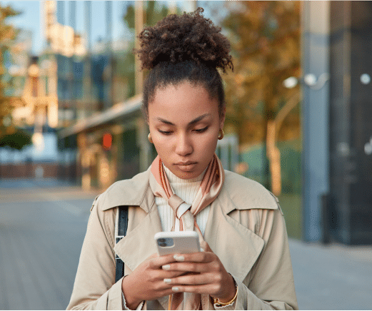 https://sociallyin.com/wp-content/uploads/2024/09/curly-haired-woman-phone.png