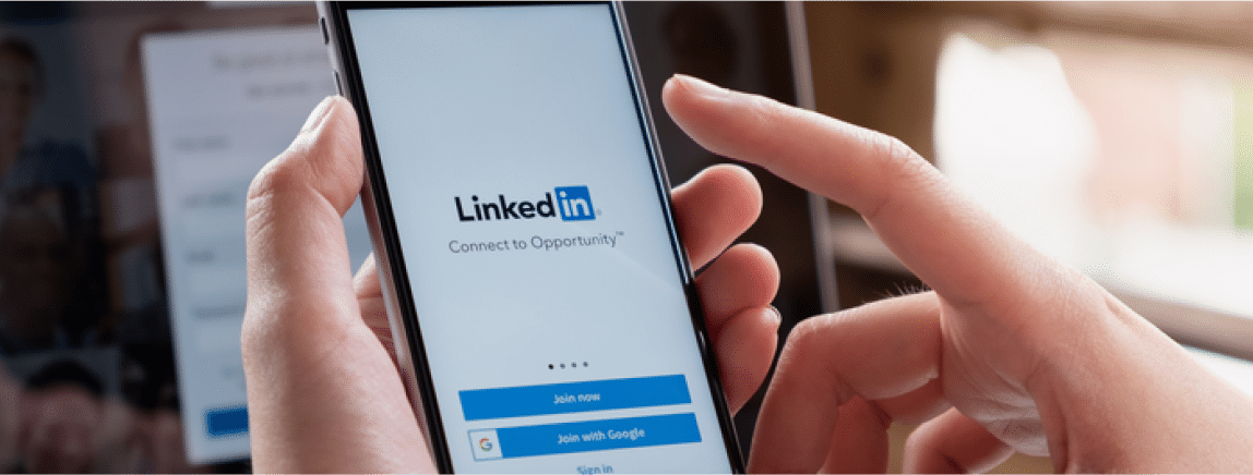 woman holding phone opening linkedin application