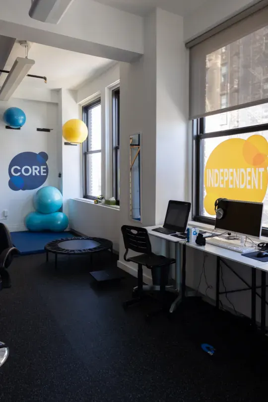 An empty center room with CORE and INDEPENDENT wall graphics
