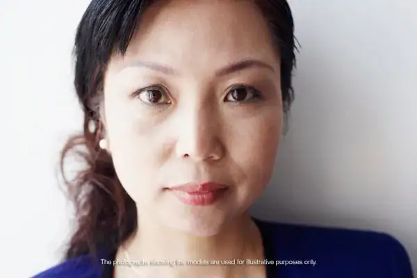 Recruitment portrait of a woman looking into the camera, with the line: the photographs showing the models are used for illustrative purposes only.